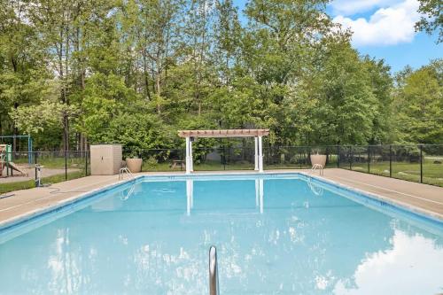 a large swimming pool with a pergola at Blue Diamond Hot Tub Fire Pit 3 BDR in Tobyhanna
