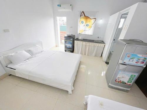 a bedroom with a white bed and a cat on the wall at Hoe Stay - Where to stay in Hanoi