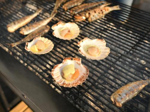 a bunch of food cooking on a grill at Holiday Home near Alabaster Coast in Les Grandes-Ventes