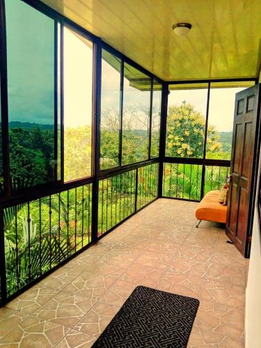 a room with a balcony with a view at Villa Guarias in Puntarenas