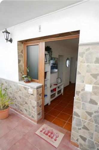 a living room with a stone wall at Terraza, céntrico pueblo aparcamiento cerca in Icod de los Vinos