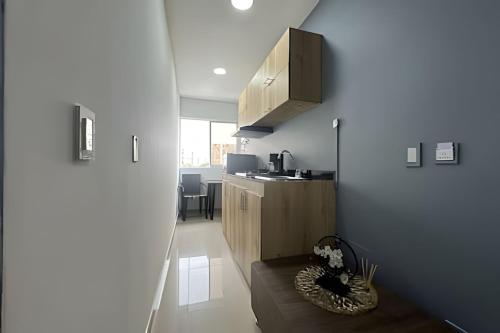 a room with a kitchen with a counter and a table at Studio in the Flora jacuzzi406 in Cali