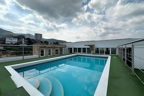 a swimming pool on the roof of a building at Studio in the Flora jacuzzi406 in Cali