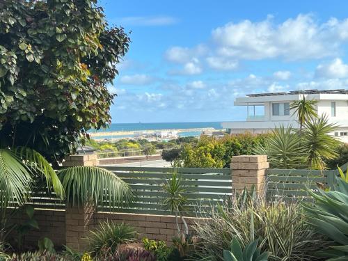 a view of a house from a garden at Ocean View Sunset Resort in Perth
