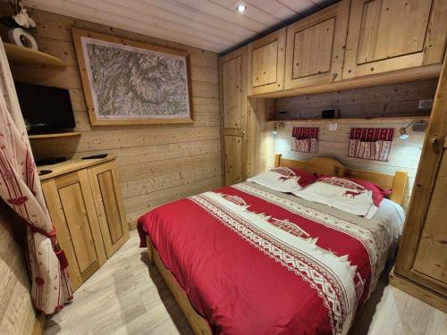 a bedroom with a bed in a wooden cabin at Appartement rénové proche des pistes avec balcon - FR-1-502-389 in Tignes