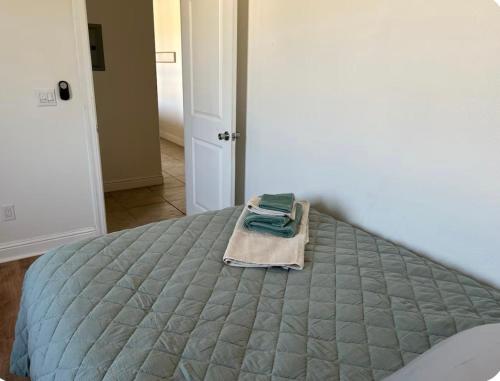 a bed with a blanket and a towel on it at The Hope Room in Redding
