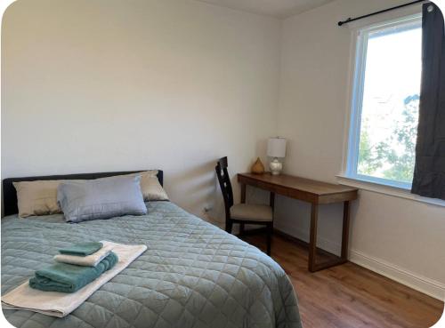 a bedroom with a bed and a desk and a window at The Hope Room in Redding