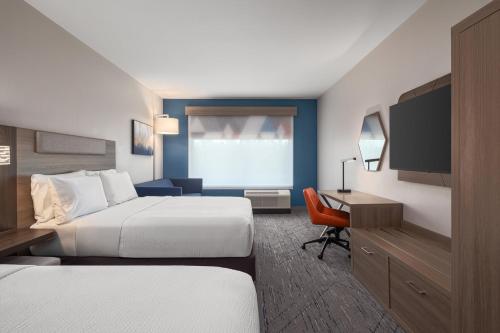 a hotel room with two beds and a desk at Holiday Inn Express & Suites Buford - Mall of Georgia by IHG in Buford