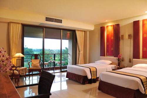 Ένα ή περισσότερα κρεβάτια σε δωμάτιο στο Hillside Country Home Golf and Resort