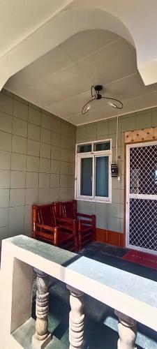a room with chairs and a table and a window at R Beach House - Malapascua in Daanbantayan
