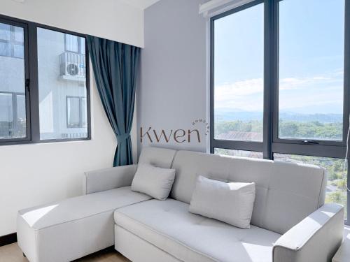 a living room with a white couch and large windows at KWEN Vetro11 - Charm of KK City in Kota Kinabalu