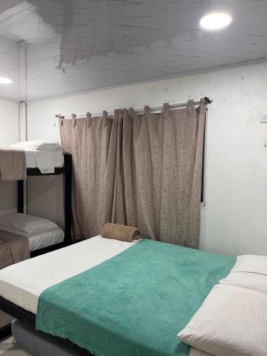 a room with two beds and a window at Villa Cris Minca in Minca