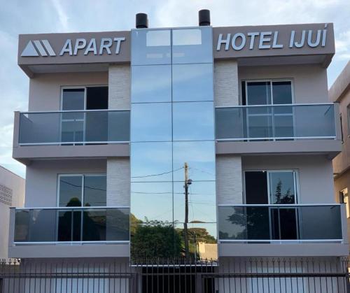 a hotel with a sign on the side of a building at IJUÍ APART HOTEl in Ijuí