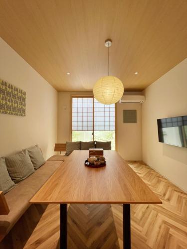a living room with a table and a couch at KawaKawa 川川 in Kyoto