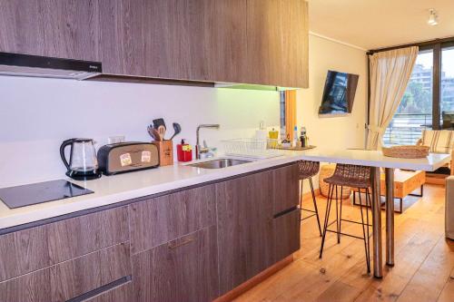 a kitchen with a sink and a counter top at HOM I Depto con Gran Terraza con Vista al Lago in Puerto Varas
