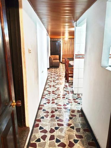 a hallway with a tile floor and a door at Comodo Alojamiento en el centro de Pereira in Pereira