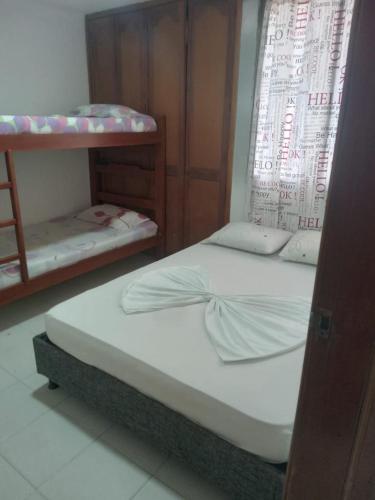 a bedroom with two bunk beds and a window at Hospedaje Hernández Apto 1004 in Estación El Salto