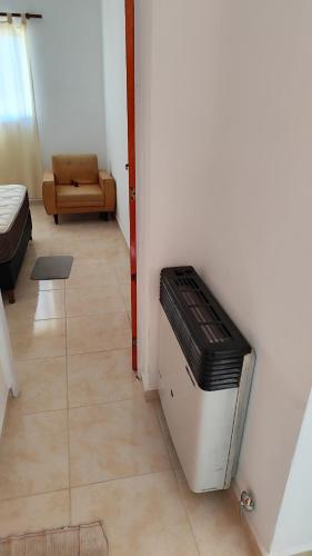 a room with a living room with a heater at Alquiler Temporario Oliva in Oliva