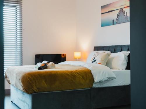 a bedroom with a bed with a stuffed animal on it at Leicestershire Aparthotels - Field Street Court in Shepshed