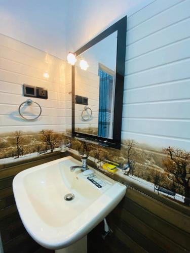 a white sink in a bathroom with a mirror at Akee villa in Matara