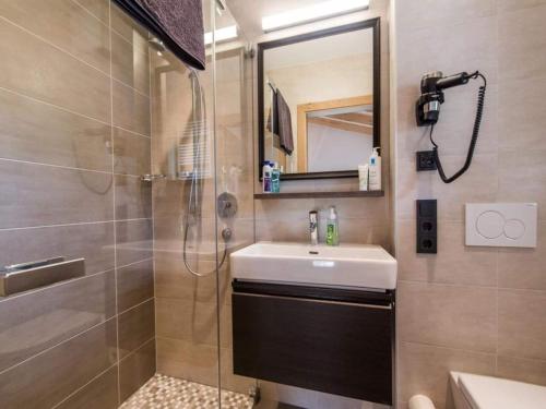 a bathroom with a sink and a shower at Chalet with Sauna and Natural Pool in Neukirchen am Großvenediger