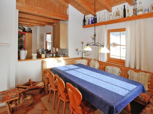 a dining room with a blue table and chairs at Chalet in Königsleiten near Zillertal Arena in Königsleiten