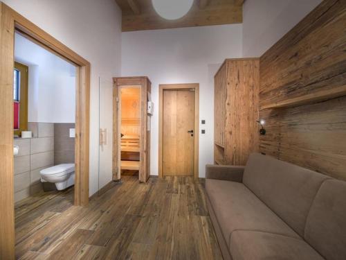 a living room with a couch and a toilet at Chalet with shared swimming pool in Neukirchen am Großvenediger