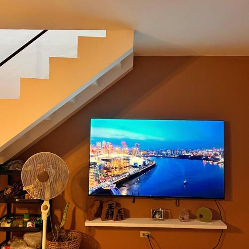 a flat screen tv sitting on a shelf in a room at RQ Pool Villa - 2 in Sampong