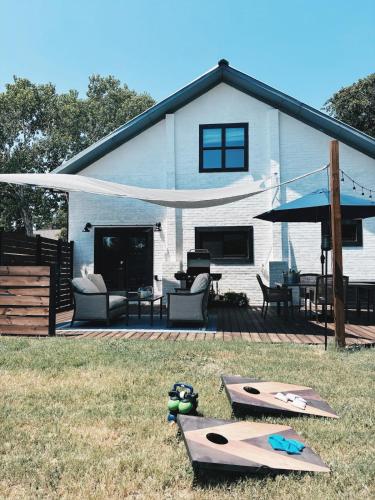 a house with a deck with two surfboards on it at Hidden Meadow - rustic hideaway in Aubrey