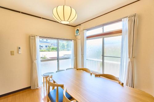 a dining room with a table and a large window at Stay as Local mizue in Tokyo