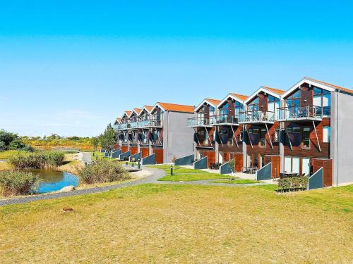 a row of apartment buildings next to a river at 4 person holiday home in Bogense-By Traum in Bogense