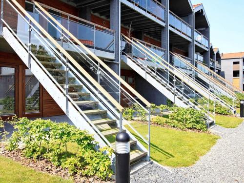 a building with stairs in front of a building at 4 person holiday home in Bogense-By Traum in Bogense