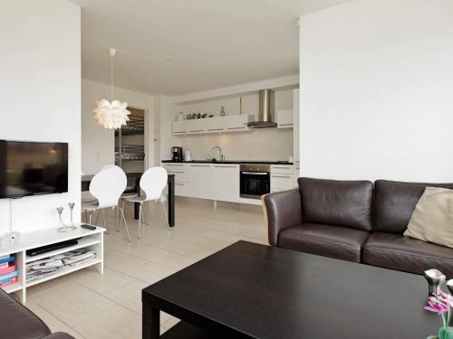 a living room with a couch and a table at 4 person holiday home in Bogense-By Traum in Bogense