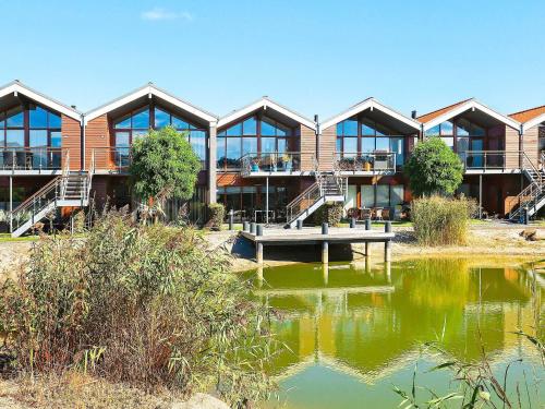 a building with a pond in front of it at 4 person holiday home in Bogense-By Traum in Bogense