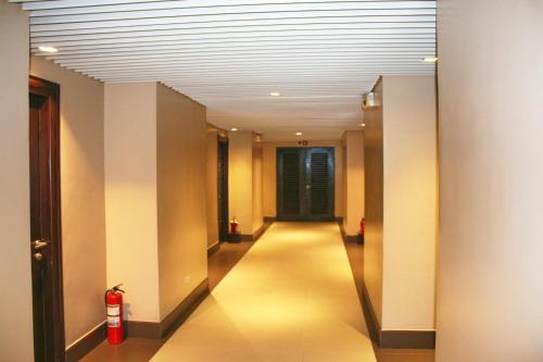a long hallway with a fire hydrant in a building at LuxeLite Suites Pasay in Pasay