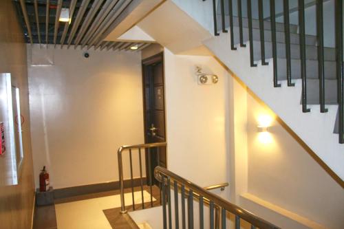 a stairway with a stair railing and a stair case at LuxeLite Suites Pasay in Pasay