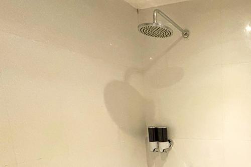 a shower with a shower head in a bathroom at LuxeLite Suites Pasay in Pasay
