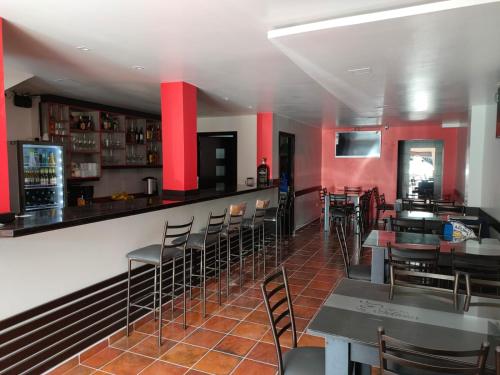 a restaurant with red walls and tables and chairs at Hotel GM Three bed 39 Zamora in Zamora