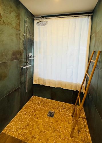 a bathroom with a shower with a shower curtain at 412 The Diamond Swing in Le Diamant