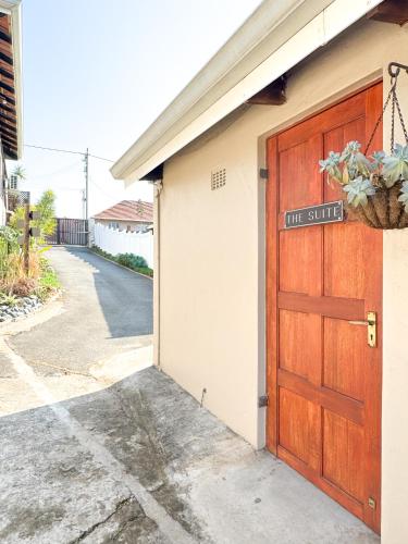 a door to a building with a tiny studio sign on it at The Boshoff in Durban