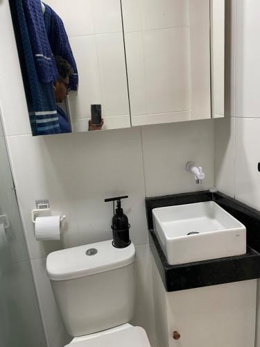 a bathroom with a toilet and a sink at Território Afeto Odara in Rio de Janeiro