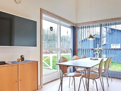 a kitchen and dining room with a table and chairs at Modern Retreat by Golf Course - By Traum Ferienwohnungen in Gudhjem