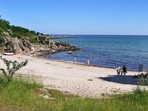 a group of people riding horses on the beach at Modern Retreat by Golf Course - By Traum Ferienwohnungen in Gudhjem