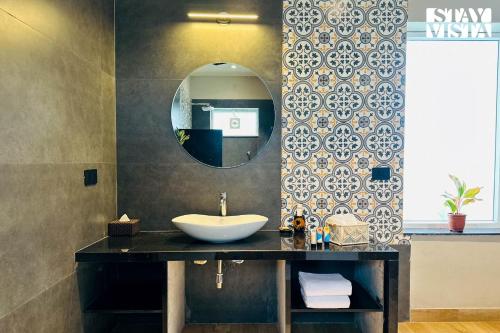 a bathroom with a sink and a mirror at StayVista at Kankas House - BBQ & Bonfire in Jaipur