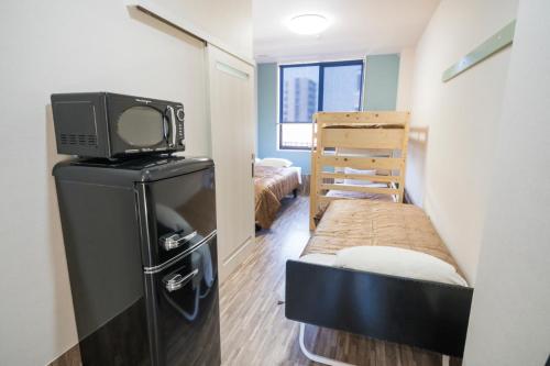 Ένα ή περισσότερα κρεβάτια σε δωμάτιο στο HOTEL 萃 the 3rd-雑餉隈駅前-無人ホテル-HOTEL SUI the third-ZASSHO-Unmanned Hotel