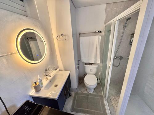 a bathroom with a toilet and a sink and a shower at Amani Grand Resort Residences Building C Unit 118 in Pusok