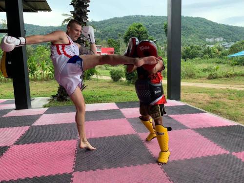 a man and a young boy doing a kick dance at March Samui Resort in Mae Nam