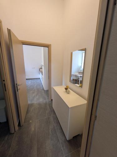 a bathroom with a white vanity and a mirror at Malpensa sweet home in Busto Arsizio