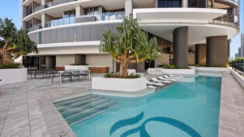 a building with a swimming pool in front of a building at Queens Wharf Luxe Retreat -Brisbane CBD, Pool, Spa in Brisbane