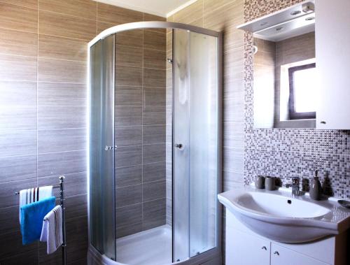 a bathroom with a shower and a sink at Apartments Marina-Mare in Poreč